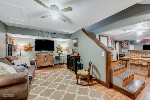 living room with ceiling fan and light hardwood / wood-style flooring