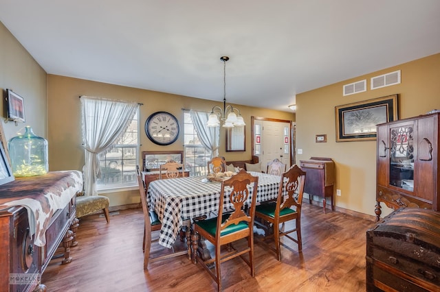 dining room featuring a chandelier and hardwood / wood-style floors