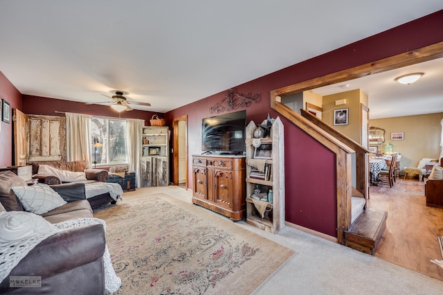 living room featuring ceiling fan and light colored carpet