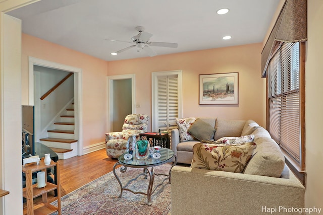 living room featuring hardwood / wood-style floors and ceiling fan