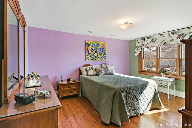 bedroom with hardwood / wood-style floors