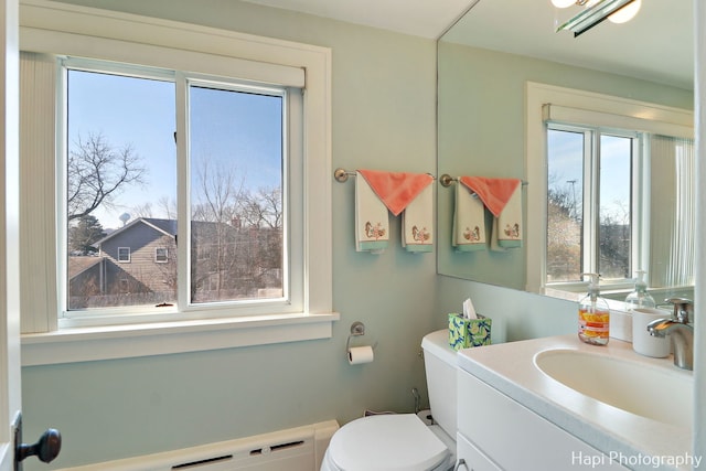 bathroom featuring a baseboard radiator, vanity, and toilet