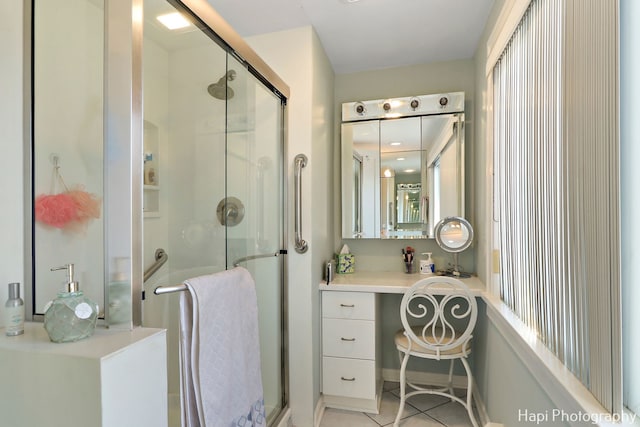 bathroom with vanity, tile patterned floors, and a shower with shower door