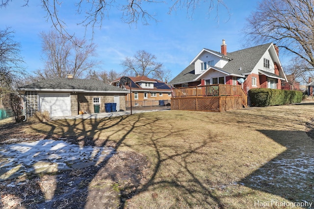 back of property featuring a deck and a lawn