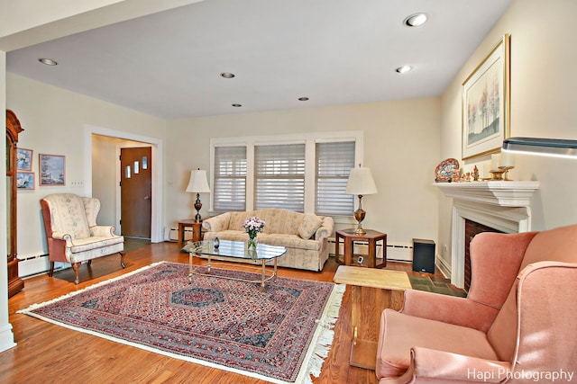 living room featuring hardwood / wood-style flooring and baseboard heating