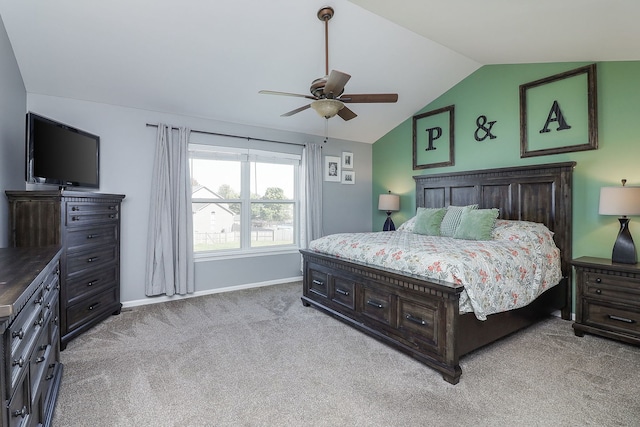 carpeted bedroom with ceiling fan and vaulted ceiling