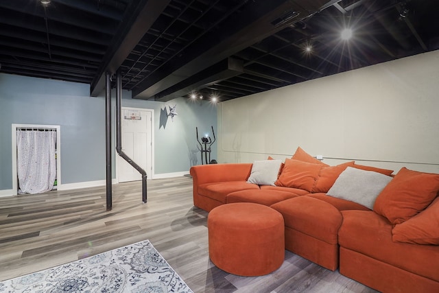 living room featuring beam ceiling and wood-type flooring