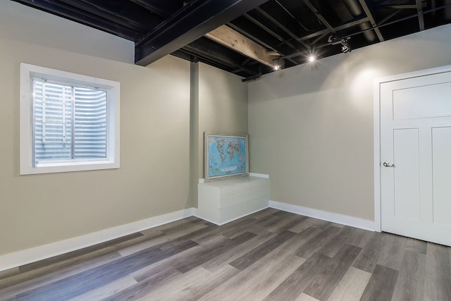 basement with dark wood-type flooring