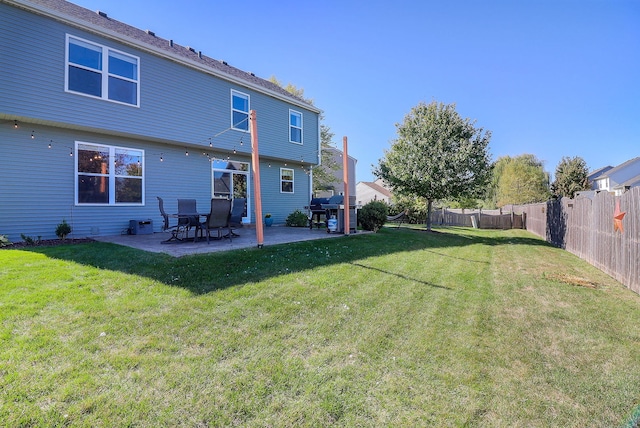 back of property featuring a yard and a patio