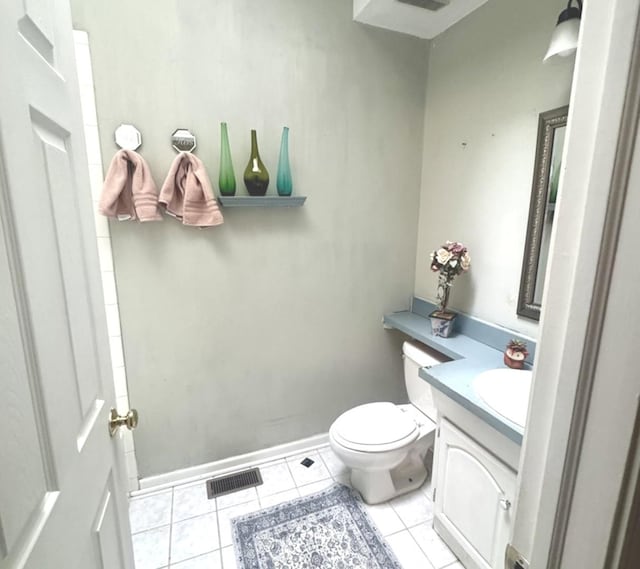 bathroom with tile patterned flooring, vanity, and toilet