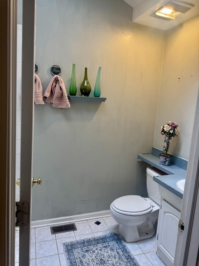 bathroom with tile patterned flooring, vanity, and toilet