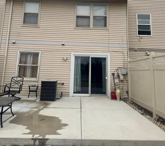 rear view of property featuring a patio and cooling unit