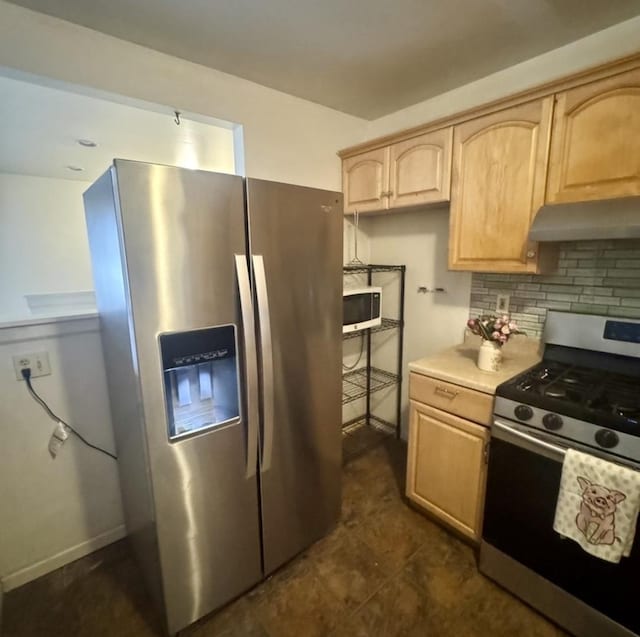 kitchen with appliances with stainless steel finishes, light brown cabinetry, and backsplash