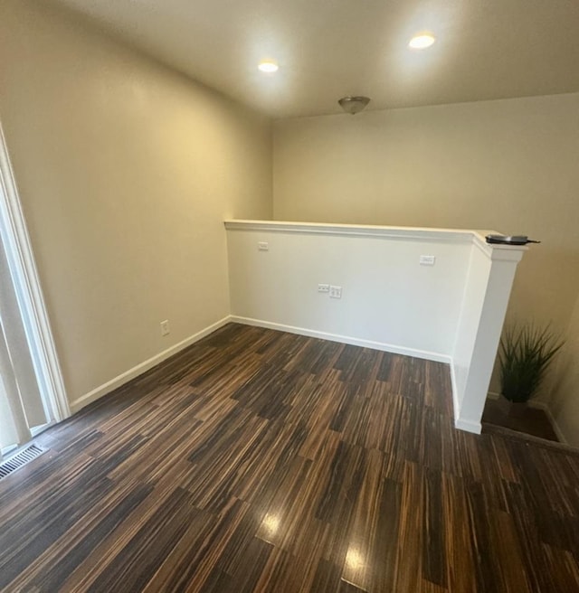 spare room with dark hardwood / wood-style floors