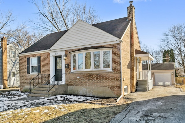 view of front of house featuring a garage and an outdoor structure