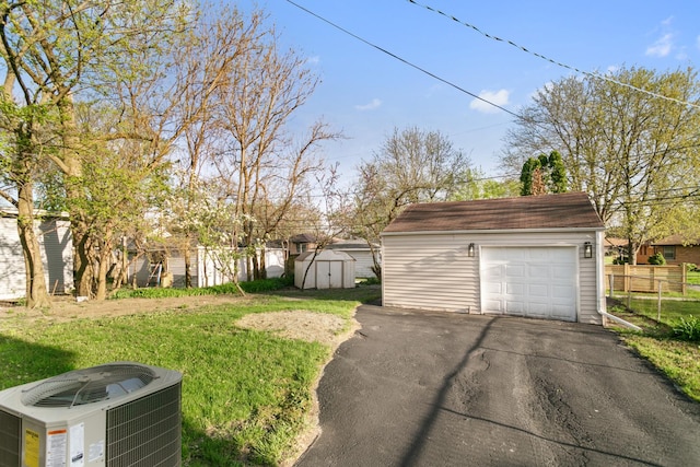 rear view of property with brick siding, central air condition unit, a yard, and fence