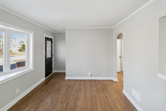 unfurnished room featuring crown molding and wood-type flooring