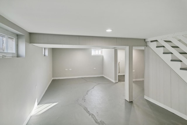 basement with stairway, baseboards, and recessed lighting
