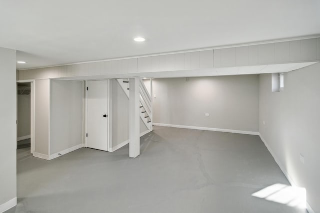 below grade area with recessed lighting, baseboards, and stairs