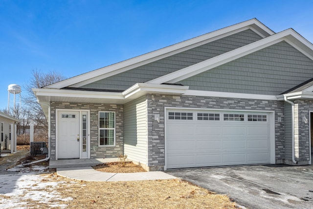 view of front of home featuring cooling unit and a garage