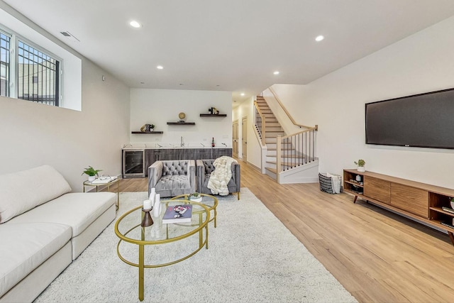 living room with wine cooler and light hardwood / wood-style floors