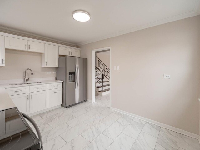 kitchen featuring white cabinetry, sink, crown molding, and stainless steel fridge with ice dispenser