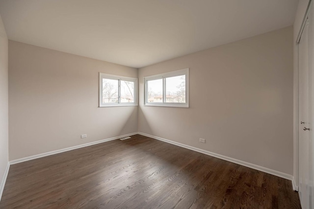 empty room featuring dark hardwood / wood-style floors