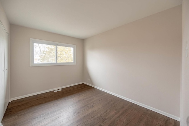 unfurnished room featuring dark hardwood / wood-style flooring