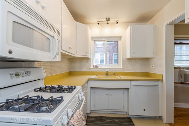 kitchen featuring white cabinetry, white appliances, and sink