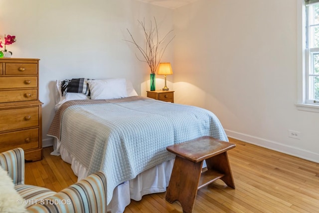 bedroom featuring multiple windows and light hardwood / wood-style floors