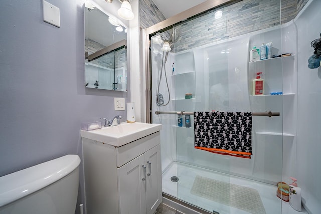 bathroom with vanity, toilet, and an enclosed shower