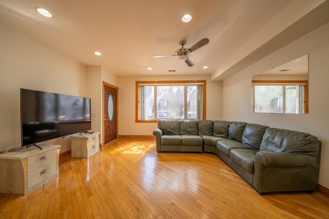 living room with ceiling fan and light wood-type flooring