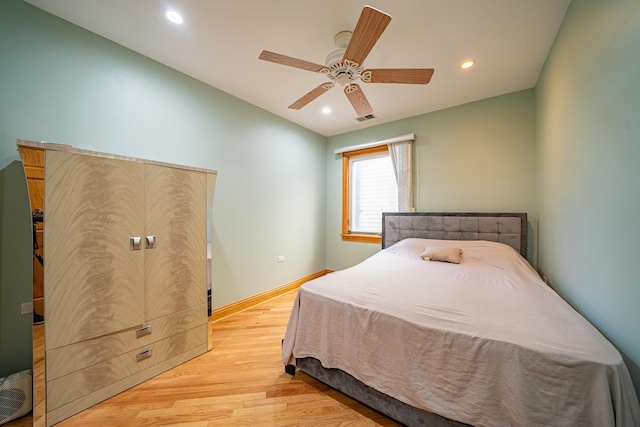 bedroom featuring light hardwood / wood-style flooring and ceiling fan