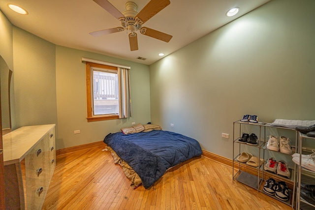 bedroom with ceiling fan and light hardwood / wood-style flooring