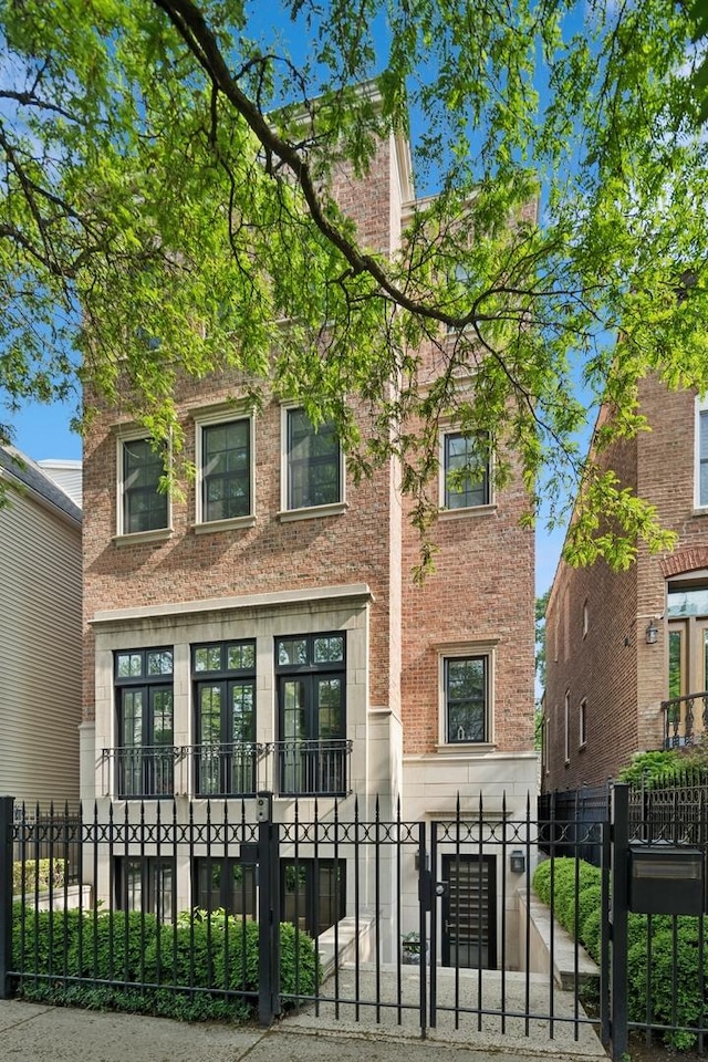 1112 W Wrightwood Ave, Chicago, IL 60614 - view of front of house with brick siding, a fenced front yard, and a gate