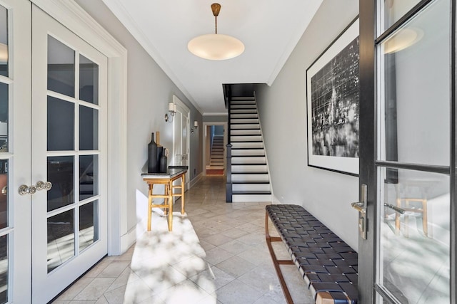 tiled foyer entrance with crown molding and french doors