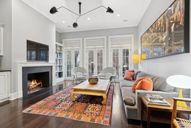 living room featuring ornamental molding and dark wood-type flooring