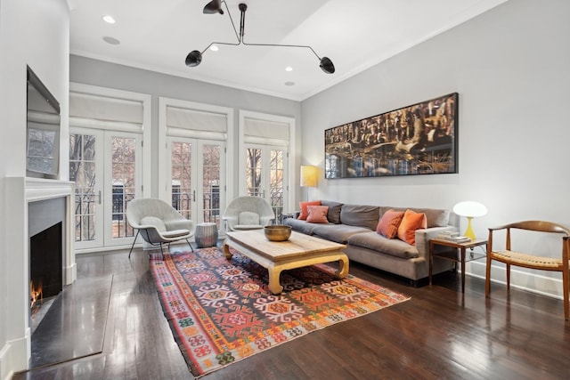 living room featuring french doors, ornamental molding, and dark wood-type flooring