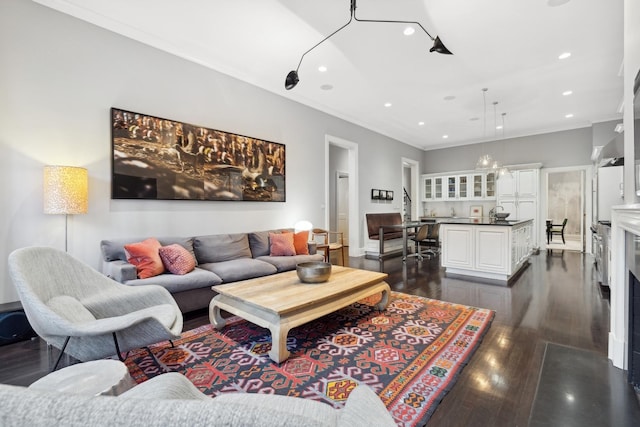 living room with dark hardwood / wood-style flooring and ornamental molding