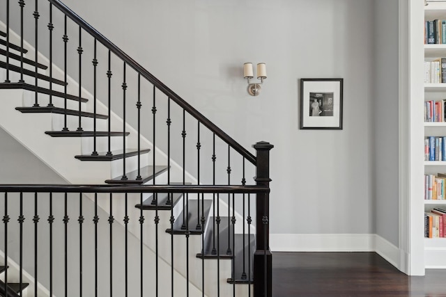 stairway featuring wood-type flooring