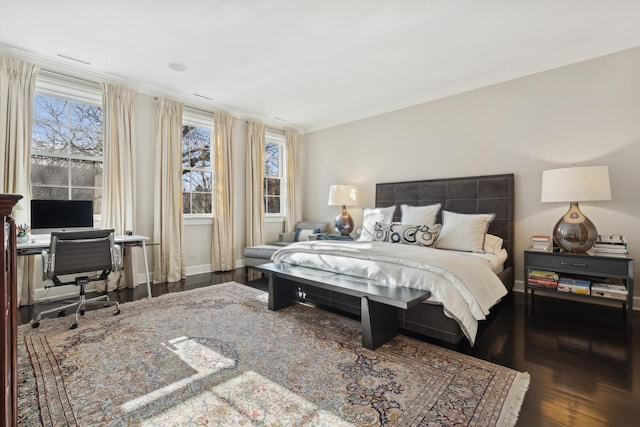 bedroom with dark wood-type flooring and crown molding