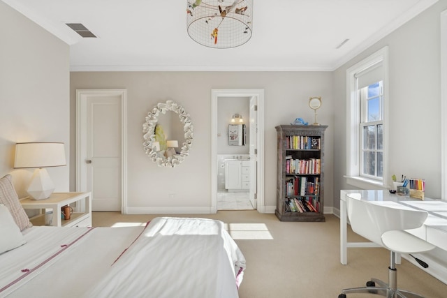 carpeted bedroom with ensuite bath and ornamental molding