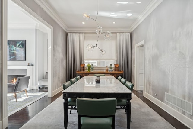 dining area featuring ornamental molding and dark hardwood / wood-style floors