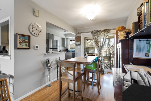 dining space with wood-type flooring