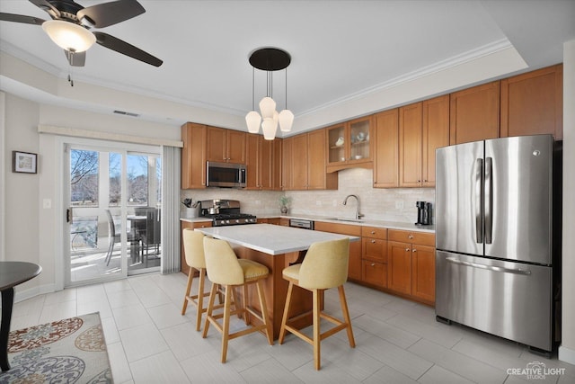 kitchen with backsplash, decorative light fixtures, stainless steel appliances, and a kitchen breakfast bar