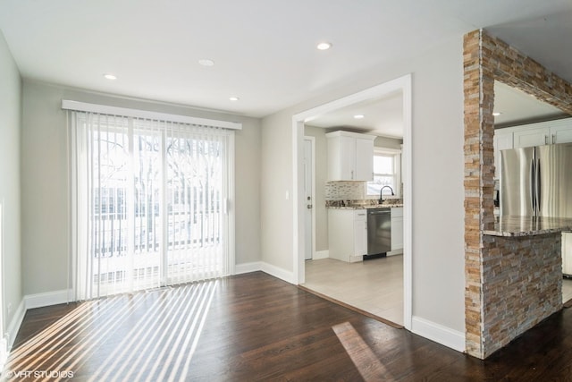 unfurnished living room with sink and dark hardwood / wood-style floors