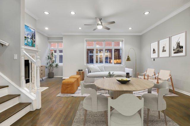 dining area with dark wood-type flooring, ornamental molding, and ceiling fan