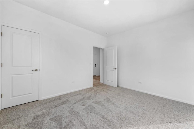 empty room with light colored carpet