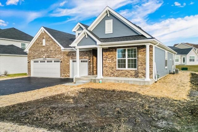 view of front of property with cooling unit and a garage