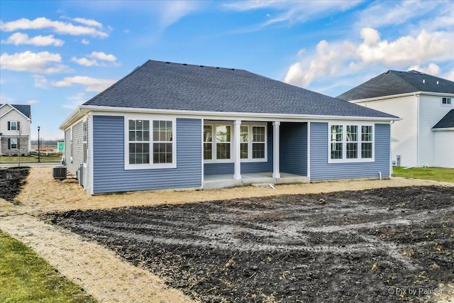 rear view of property featuring central AC unit